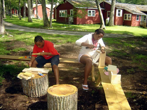 Amber and Nateisha finish their woodworking projects